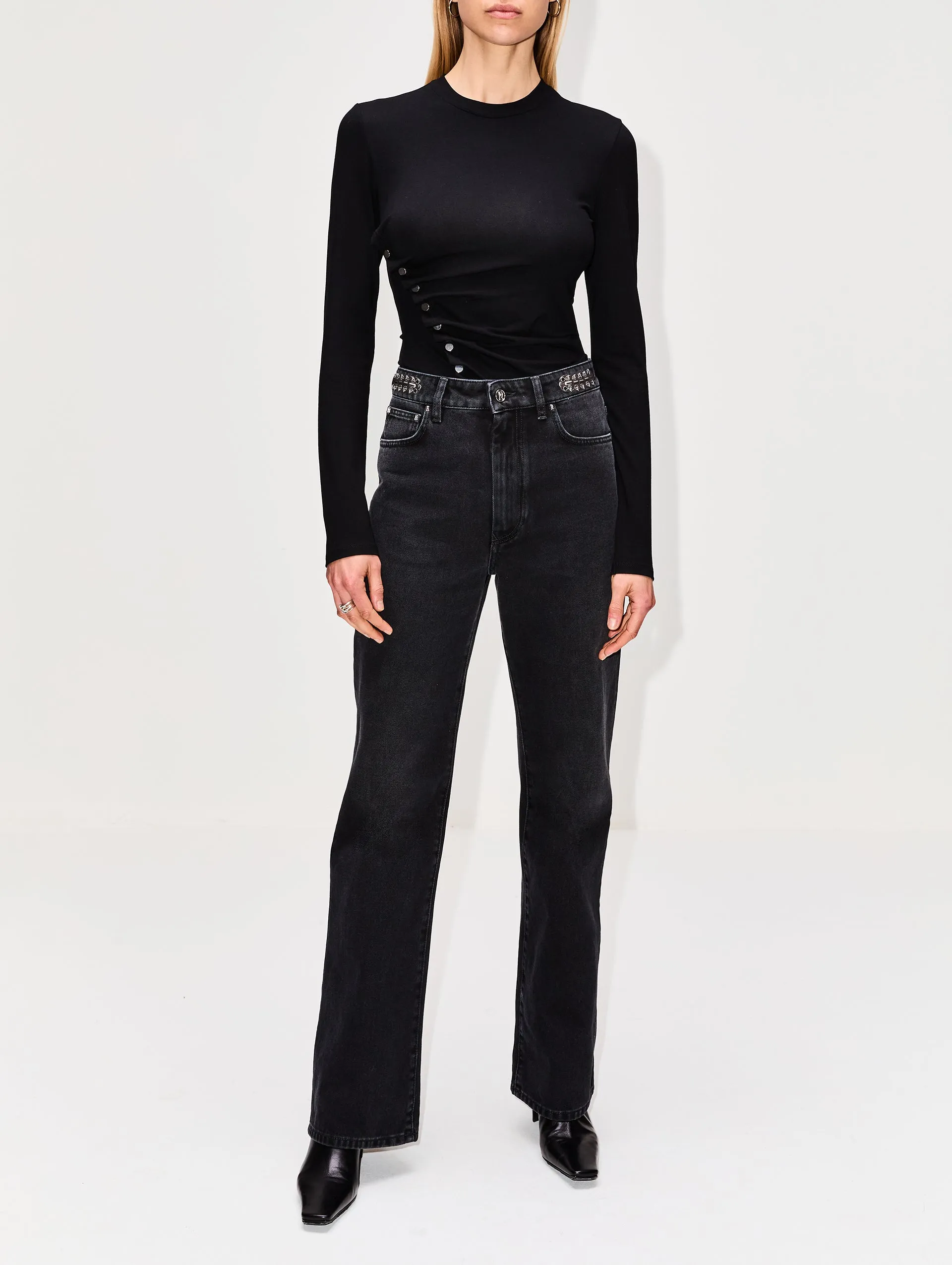 High-rise waist jeans with detailed embellishments.